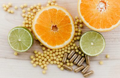 oranges, peas, and limes on a wooden table